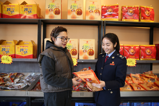 永福县税务局青年干部在桂林永福香盈八方食品有限公司实地走访,了解公司经营情况、产品销售情况,并讲解适用税收优惠政策。蒙玉秀摄